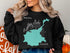 Black sweatshirt with "Beautiful Timothy Lake Oregon" and compass rose graphic.