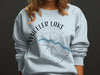 Light blue sweatshirt with Wheeler Lake Alabama design and compass graphic.