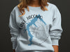 Light blue sweatshirt with blue Lake Jacomo map and compass graphic.