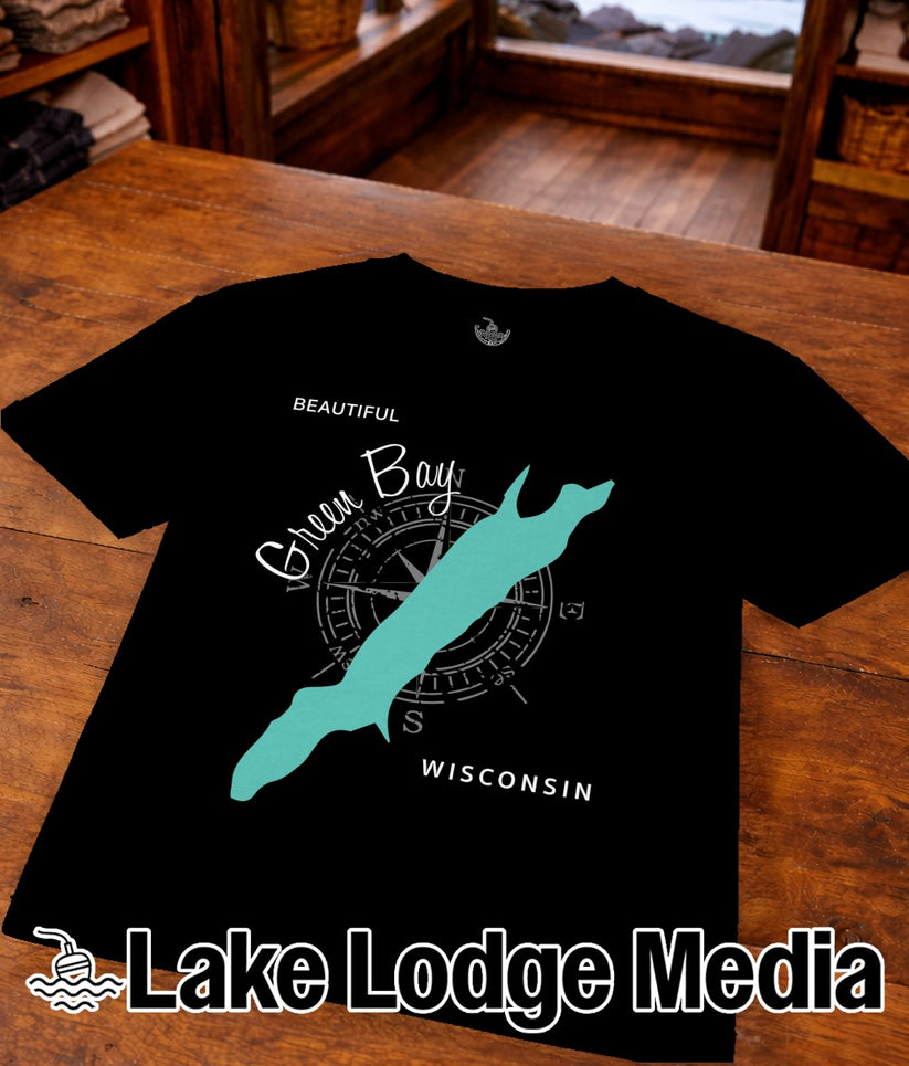Black t-shirt featuring a compass, "Beautiful Green Bay Wisconsin" text, and turquoise bay outline.