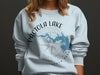 Light blue sweatshirt with Pictola Lake map and compass graphic.