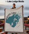 Woven blanket with map of Indian Lake, Ohio, held by a smiling man.