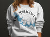 White crewneck sweatshirt with blue Lake Tobesofkee map and compass graphic.