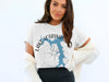 White t-shirt with blue Lake of the Ozarks map and compass graphic.
