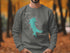 Dark gray sweatshirt with Lake Quivira map and compass graphic.