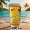Beer glass with "SWAP LAKE" and a blue lake map graphic on a beach.