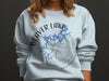 Beaver Lake Arkansas graphic on light blue crewneck sweatshirt with compass rose.