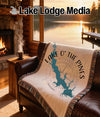 Woven blanket with a lake map and compass rose design reading "Lake O' The Pines Texas".