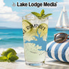 Tall glass with Lake Rampart design, lime, mint, and ice, beach background.