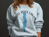 Light blue sweatshirt with "White Rock Lake Texas" and compass design.