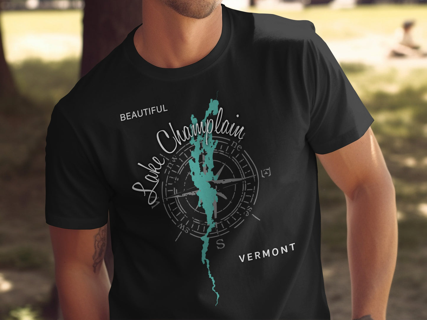 Black t-shirt with "Lake Champlain Vermont" map and compass design.