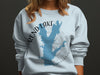 Light blue sweatshirt with Rend Lake Illinois map graphic and compass rose.