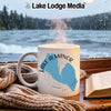White mug with Lake Almanor California map and steam in front of rainy lake window