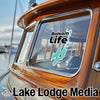 Balsam Life logo sticker on a boat window, with "Lake Lodge Media" text.