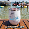 White insulated tumbler featuring a Key West compass design rests on a wooden boat deck.