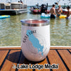 A white insulated wine tumbler with a Gull Lake, Michigan map graphic rests on a wooden dock with a lake scene in the background.