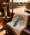 Lake Michigan outline map on a compass design woven blanket with fringe.