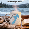 White mug with "Eagle Lake California" design and steam, by a window.