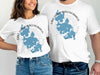 White t-shirts with Lake Chaubunagungamaug, Massachusetts map and compass graphic.