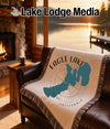 Woven blanket with Eagle Lake California map design on leather couch.