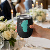 Black tumbler with teal Lake Tahoe map and text, held at a formal event.