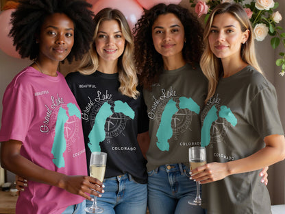 Four women wearing t-shirts with "Grand Lake Colorado" and compass design.