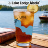Glass of iced tea with a lemon slice, featuring a light blue lake map and compass design.