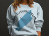 White sweatshirt with blue Rattlesnake Lake, WA graphic and compass rose.