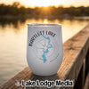 White insulated wine tumbler featuring a blue Bartlett Lake map and compass graphic, resting on a wooden dock.
