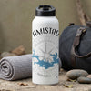 White water bottle with "AMISTAD" text and compass design on a textured background.