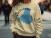 Tan sweatshirt with blue Emerald Lake Canada graphic and compass rose.