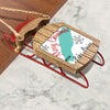 Wooden sled ornament with "Merry Christmas FROM Lake Louise" text and snowflakes.