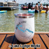 A white stainless steel tumbler with an Alder Lake Washington design rests on a wooden boat deck.