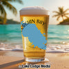 Glass of beer with "Georgian Bay Ontario" text and map graphic on beach background.