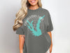 Gray t-shirt with Calaveras Lake map and compass graphic, text "TEXAS".