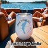 A white stemless wine tumbler with Long Pond Lake New Hampshire graphics rests on a wooden boat table.