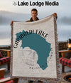 Man holding Garibaldi Lake, British Columbia map blanket with compass design.
