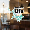 Hamilton Life sticker with teal lake outline and text.