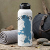 White insulated bottle with "HEAD LAKE" and blue map graphic, by a rolled towel and duffel bag.