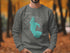 Grey sweatshirt with a teal outline map of Lake Okeechobee, Florida.