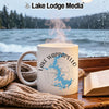 White mug with Lake Wappapello Missouri design and steam rising, next to a book and scarf.