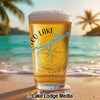 Glass of beer on beach, featuring "Co Lake" and compass design.