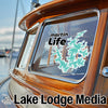 Boat window with "martin Life" text and teal tree graphic; "Lake Lodge Media" text below.