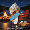 Glass of ice cream dessert with s'mores ingredients on a table by a campfire.