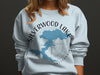 Light blue sweatshirt with Silverwood Lake California map and compass design.