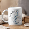 White mug with Lake Wylie map and compass design, steaming.