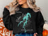 Black sweatshirt with "Beautiful Below Lake" compass design and "North Carolina" text.