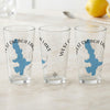Three clear glasses feature blue West Okoboji Lake maps and compass designs.