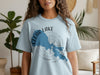 Light blue t-shirt with a blue Clear Lake, California map and compass graphic.