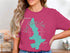 Pink t-shirt with teal West Okoboji Lake graphic and "Beautiful Iowa" text.